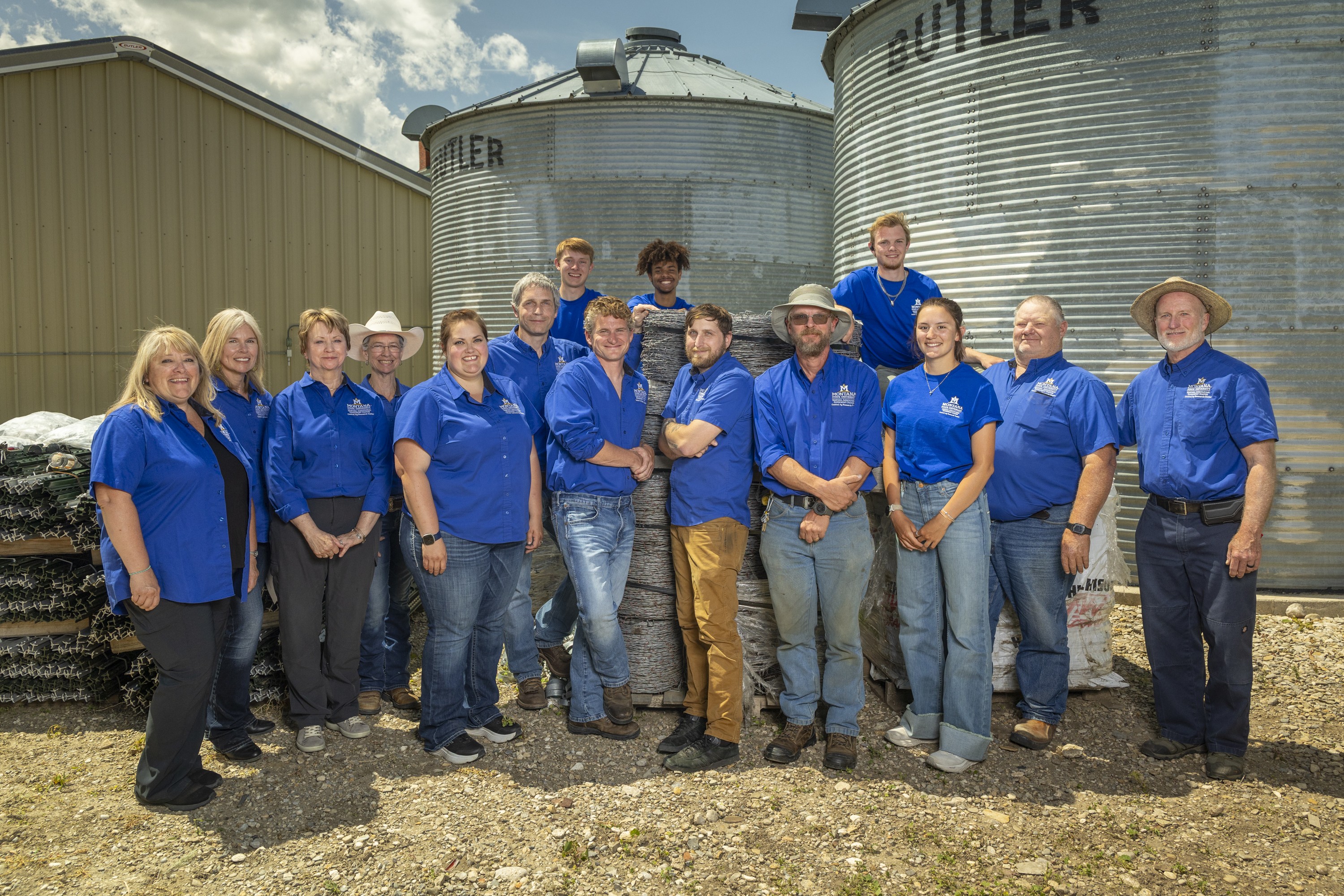 CARC staff posing by bins in blue shirts